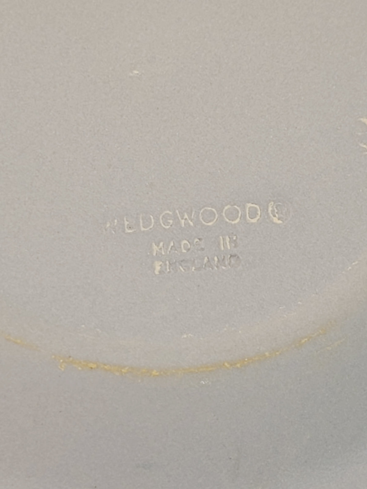 Underside of Wedgwood jasperware pin plate showing incised Wedgwood Made in England stamp, authentication mark on vintage Cancer zodiac crab plate