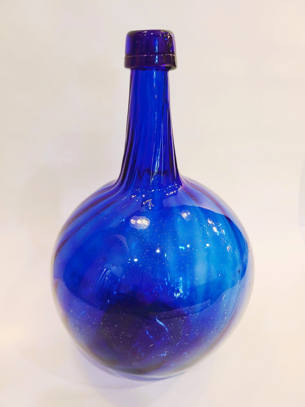 Hand-blown cobalt blue glass onion bottle with rounded body and long neck