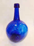 Hand-blown cobalt blue glass onion bottle with rounded body and long neck