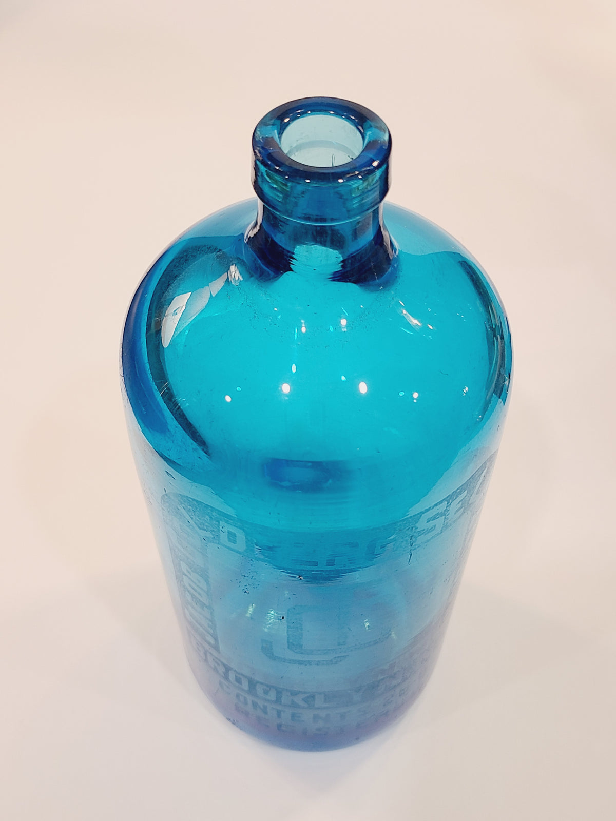 Vintage turquoise Czechoslovakian seltzer bottle with heavy glass body and open siphon neck