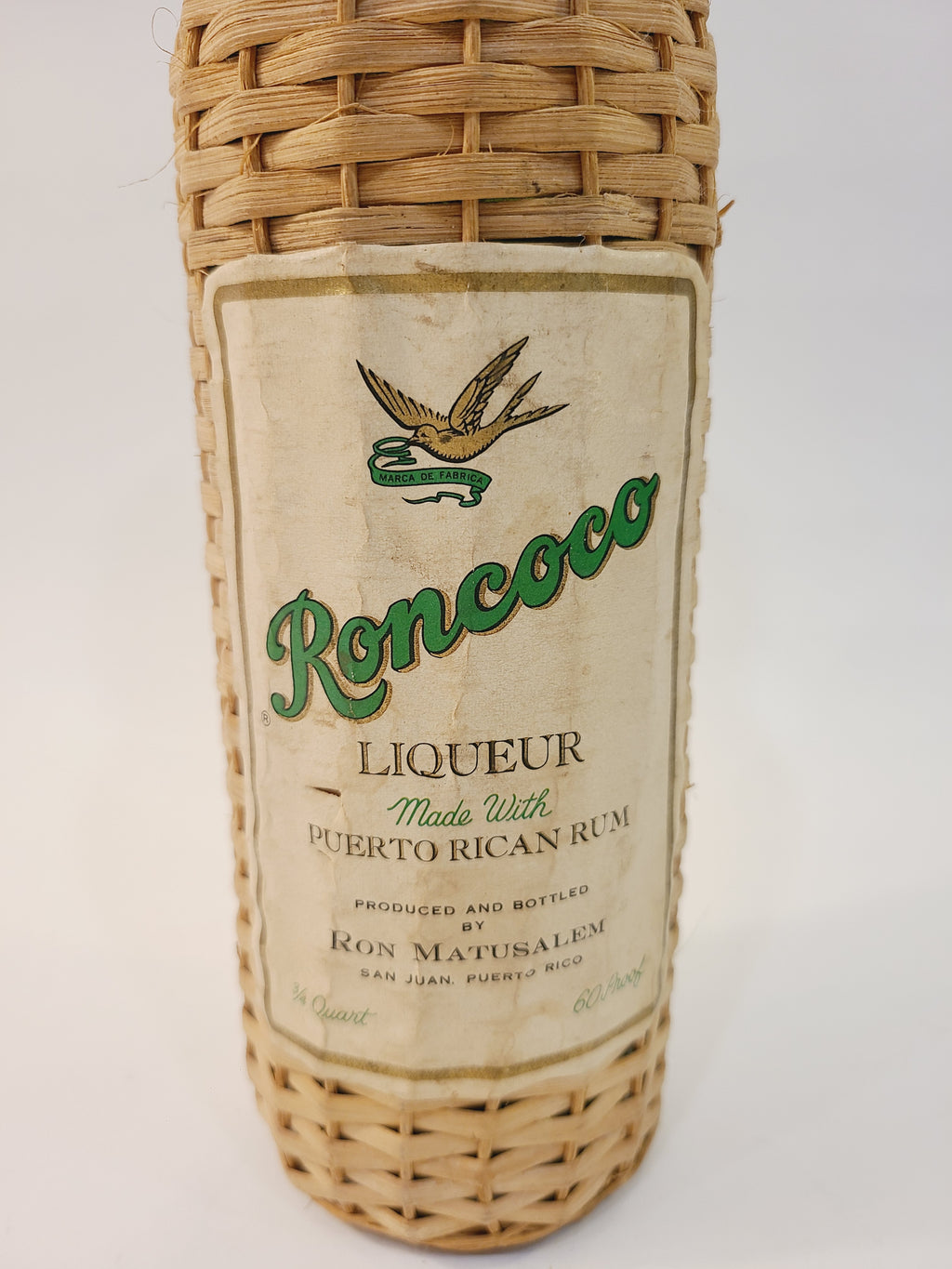 Close-up of Roncoco Liqueur front label with Ron Matusalem bird logo, vintage 1970s Puerto Rican rum barware