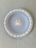 Wedgwood blue jasperware Cancer crab zodiac pin plate top view on linen, white bas-relief crab cameo centered with leaf garland border, Made in England