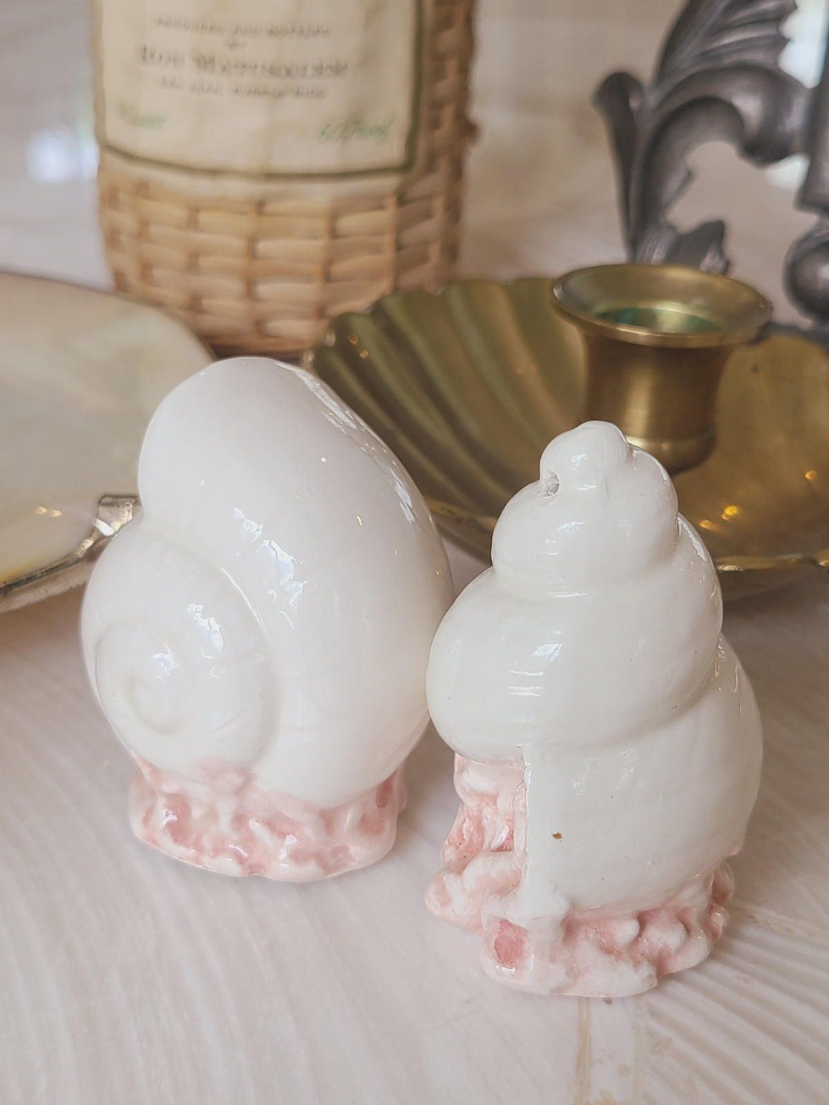 Fitz and Floyd Coquille seashell salt and pepper shaker set styled in coastal vignette with brass shell dish and candlestick, vintage ceramic tabletop decor