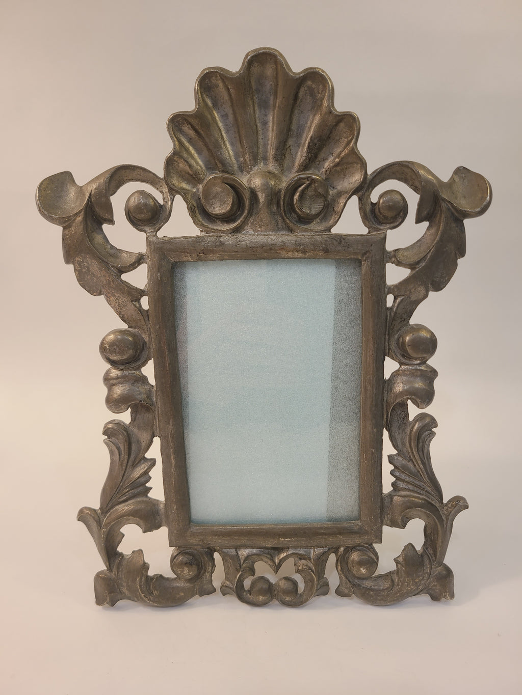 Rococo Revival cast metal tabletop picture frame with shell crest and scrolling acanthus leaves, antiqued bronze finish, circa 1950s–1970s