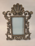 Rococo Revival cast metal tabletop picture frame with shell crest and scrolling acanthus leaves, antiqued bronze finish, circa 1950s–1970s