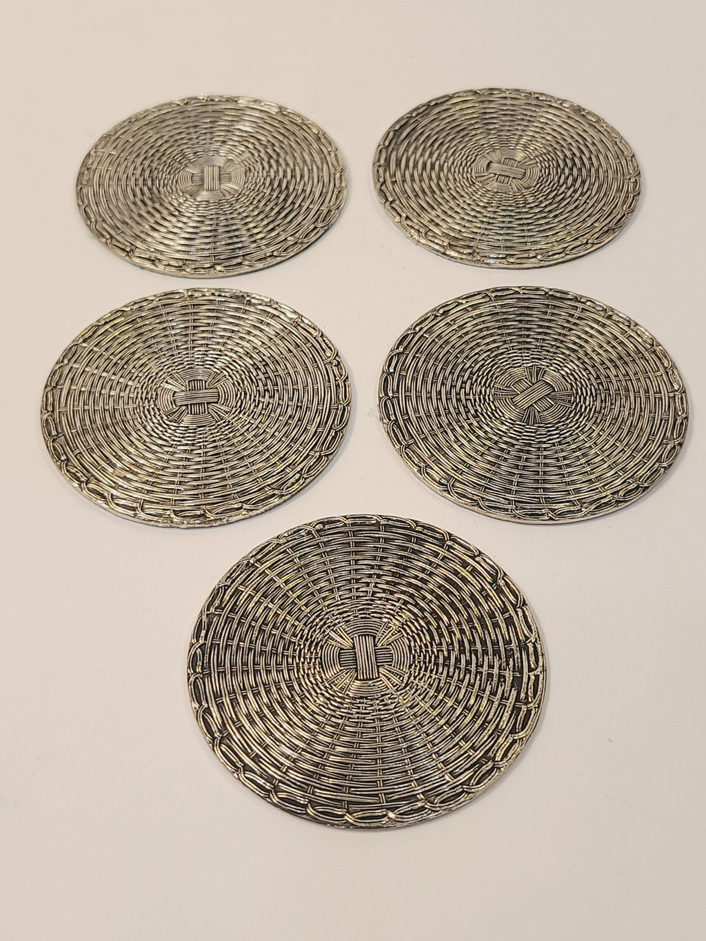 Complete set of 5 mid-century woven metal basketweave coasters laid flat, polished silver finish, French or German vintage tableware