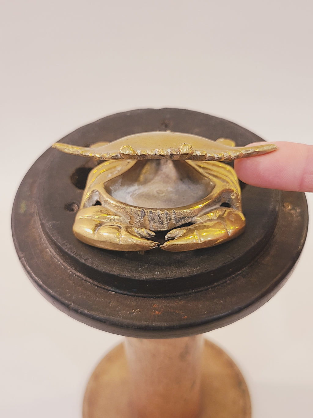 Open brass crab trinket box revealing the small hidden compartment beneath its shell