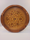 Round vintage inlaid wood serving tray with botanical scrollwork, mother-of-pearl accents, raised rim, and carved handles