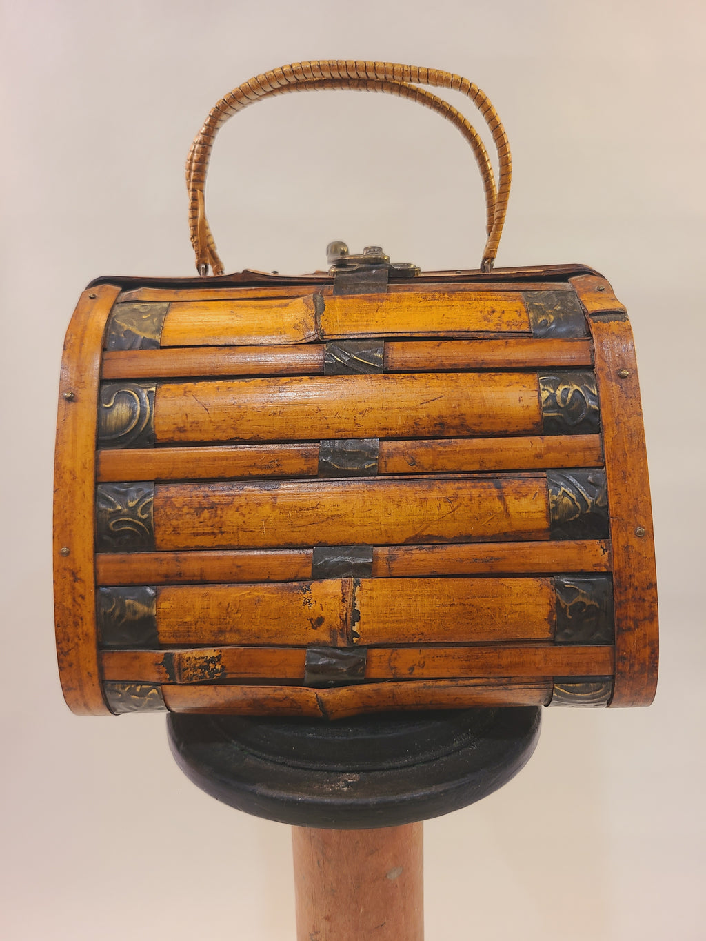 Vintage bamboo trunk box handbag with split bamboo slats, decorative metal bands, and woven reed handles