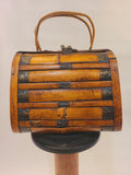 Vintage bamboo trunk box handbag with split bamboo slats, decorative metal bands, and woven reed handles