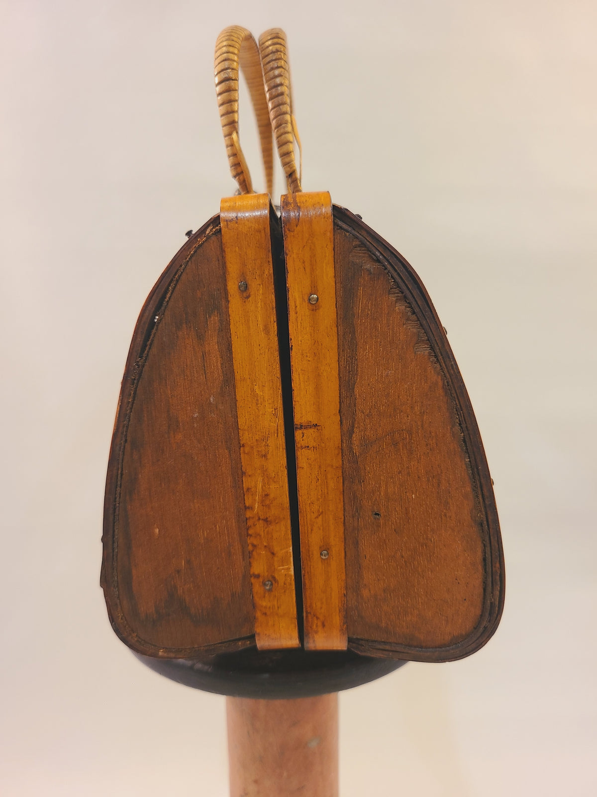 Side view of vintage bamboo trunk box handbag showing wood framing