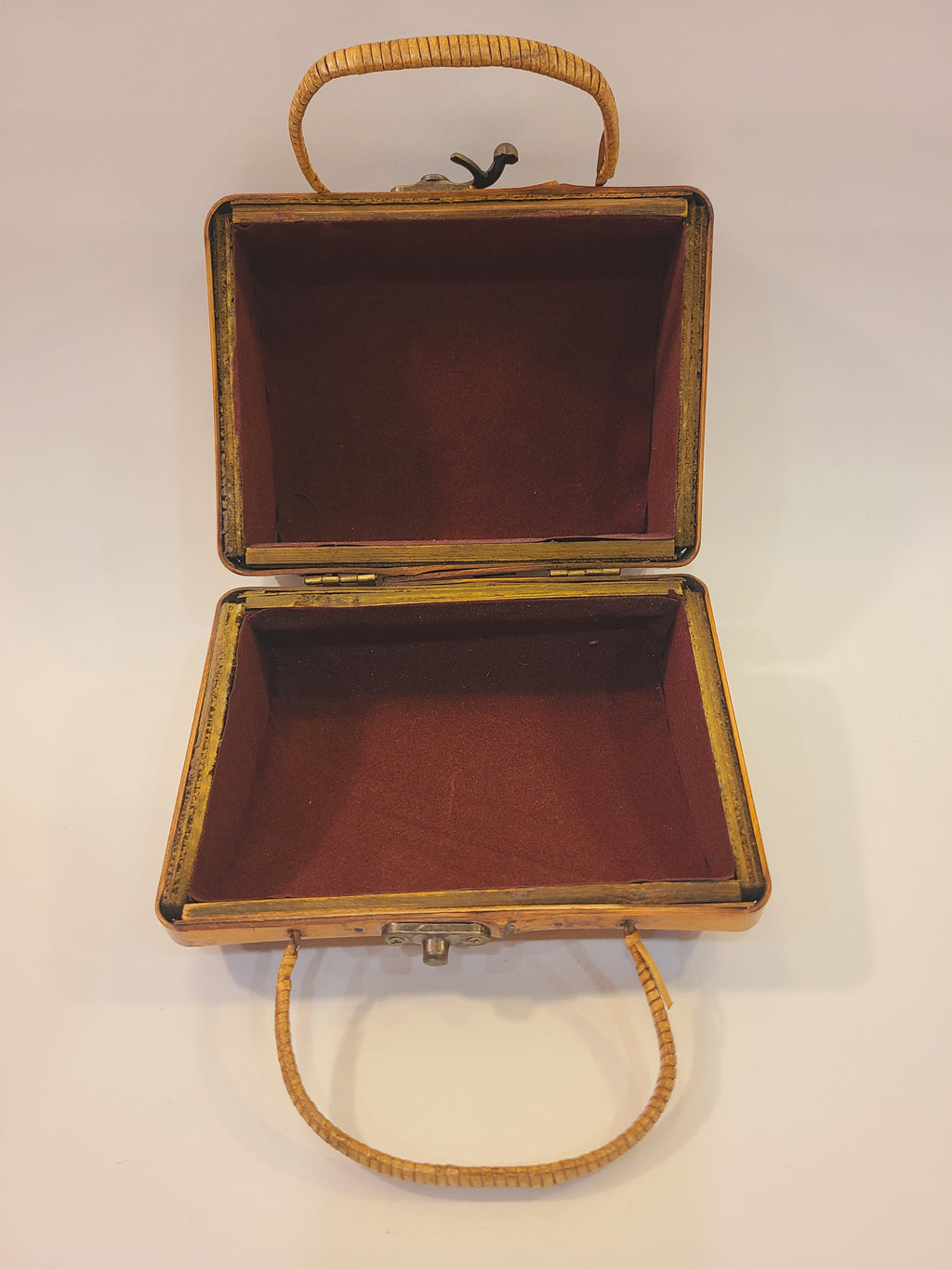 Open vintage bamboo box handbag showing burgundy velvet-like lining and a single interior compartment