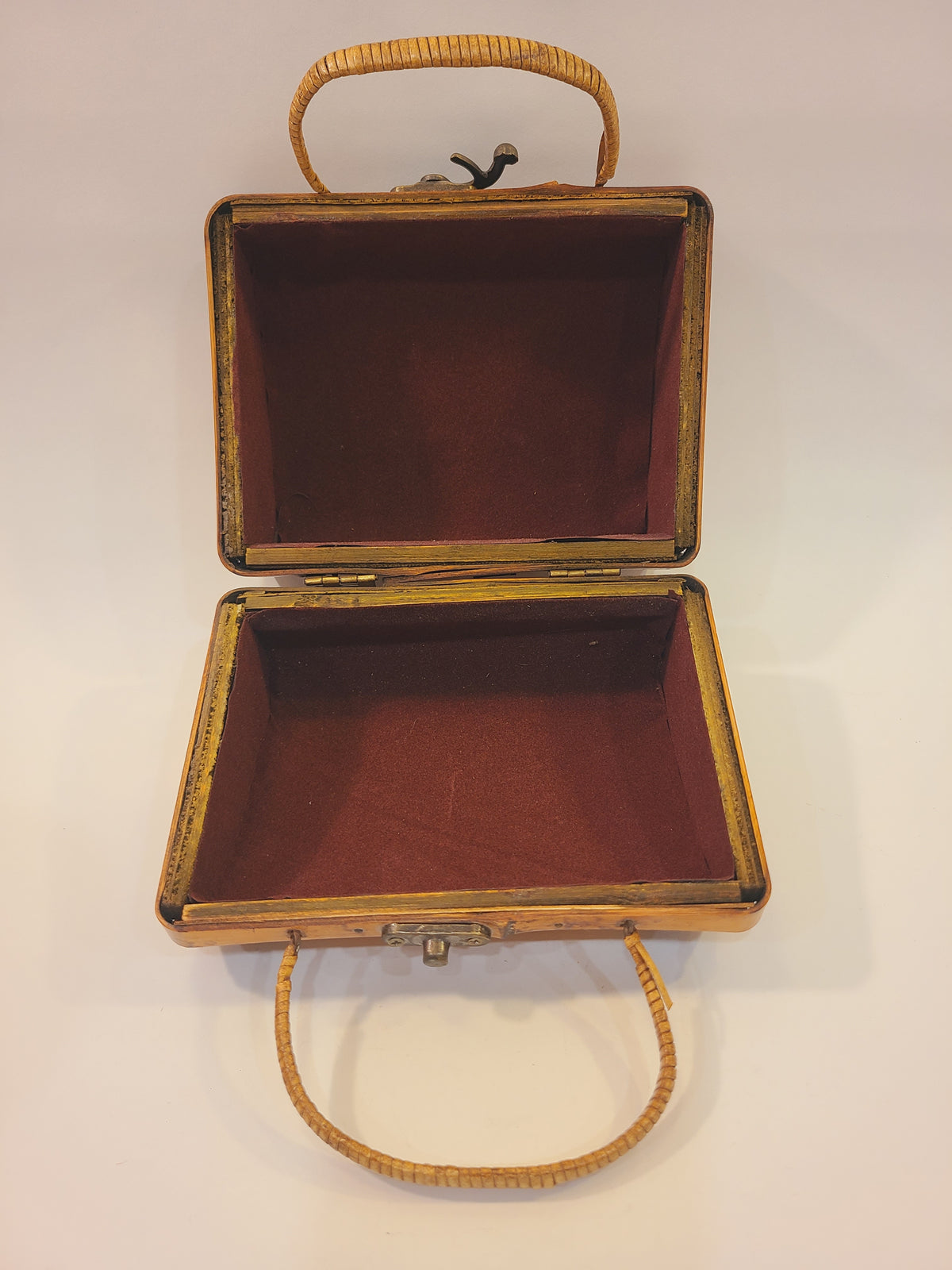 Open vintage bamboo box handbag showing burgundy velvet-like lining and a single interior compartment