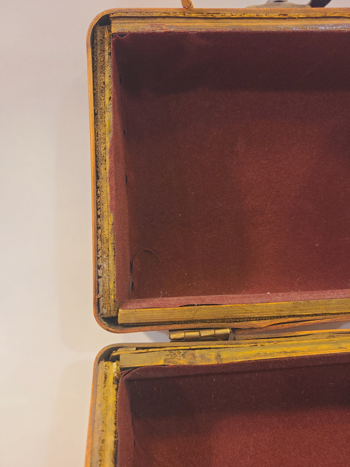 Detailed view of the burgundy-lined interior, framing, and hinged construction of a bamboo box handbag