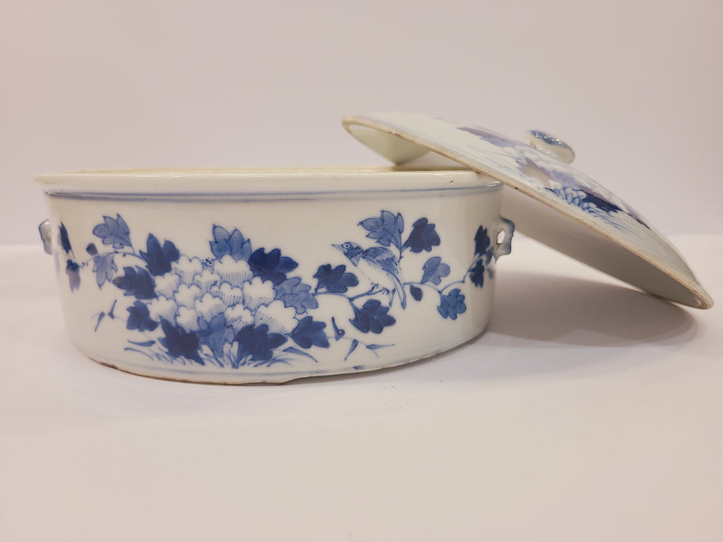 East Asia Blue and white porcelain lidded serving bowl shown from the side with the lid propped open